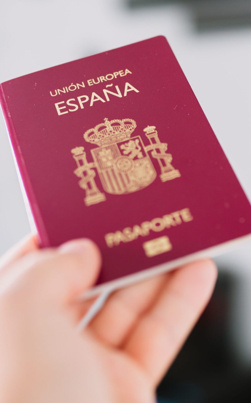 Hand holding a Spanish passport.